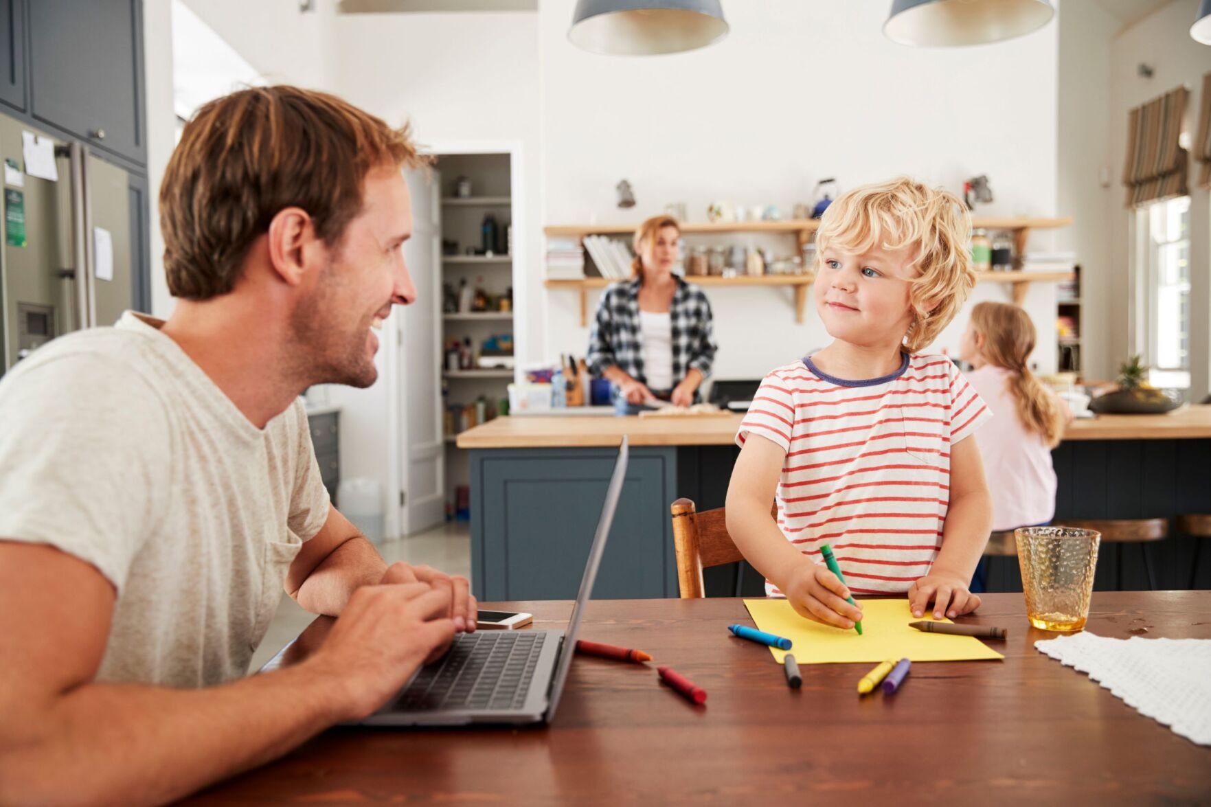 Dad working at table with boy